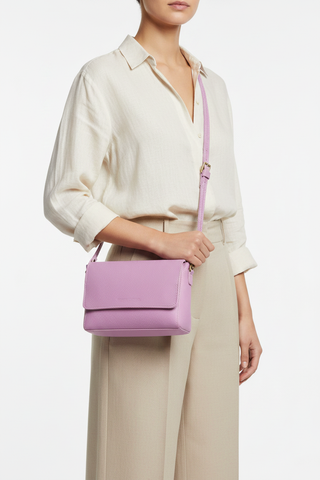 Welare Metro Full-Grain Pebbled Leather Crossbody Bag Lilac Model Wearing Crossbody White Background