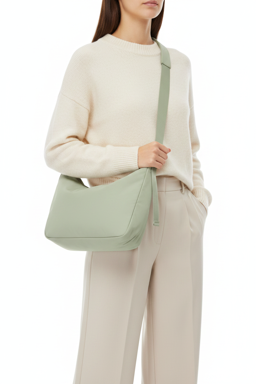 Welare Featherlight Leather Shoulder Bag Sage Green Model Wearing Over Shoulder White Background